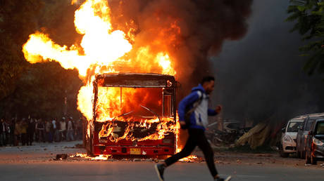 Protesters TORCH buses and clash with police in Delhi as Indian citizenship bill sparks street violence (PHOTOS/VIDEOS)