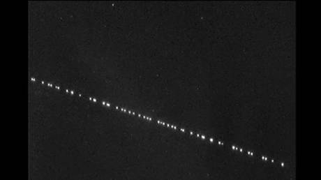 &lsquo;All hail the overlords!&rsquo;: Stargazers mystified by unexplained lights in the night sky (PHOTOS)