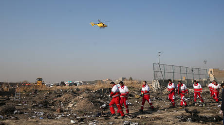 Rescue team works among debris of a plane that crashed after take-off from Iran's Imam Khomeini airport