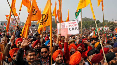 Supporters of India's ruling party hold flags as they attend a rally in support of a new citizenship law, in Lucknow, India, January 21, 2020.
