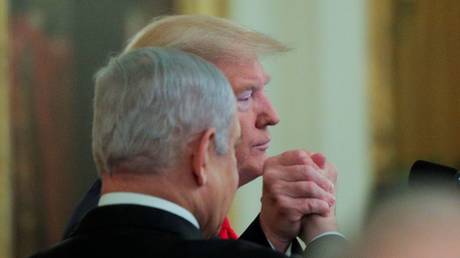 US President Donald Trump and Israel's Prime Minister Benjamin Netanyahu clasp hands at joint news conference on a new Middle East peace plan proposal