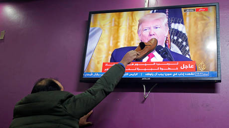 A Palestinian in a Hebron coffee shop protests US President Donald Trump's peace plan, January 28, 2020.