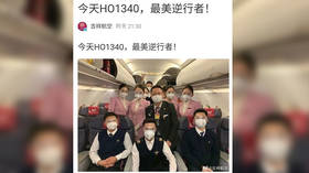 WATCH: Stranded Chinese passengers applaud as plane reroutes to quarantined Wuhan