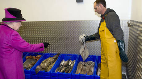 Britain's Queen Elizabeth views produce as she visits West Quay Fisheries in Sussex