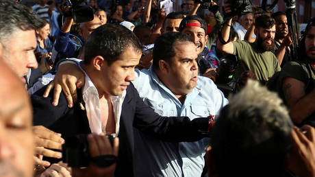 ‘Murderer!’ Protests and fights erupt as Guaido arrives at Venezuelan airport, gets booed and DOUSED with water (VIDEOS)
