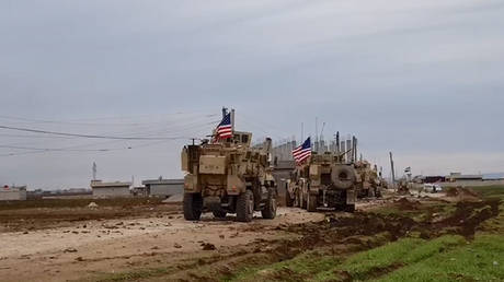 A convoy of U.S military vehicles moves in the village of Khirbet Amo, near Qamishli, Syria February 12, 2020.