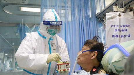 Nurse feeds a coronavirus patient at Zhongnan Hospital of Wuhan University