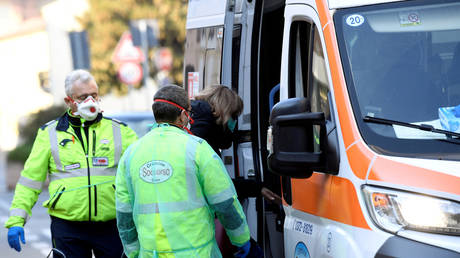 A woman is taken into an ambulance amid a coronavirus outbreak in northern Italy, in Casalpusterlengo, February 22, 2020