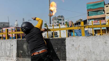Unrest over Delhi citizenship law leaves 18 dead as rival protesters face off