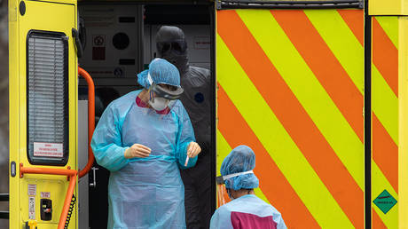 FILE PHOTO Hospital staff in full protective gear and testing kit at the back of an ambulance a St Thomas' Hospital © Global Look Press/Keystone Press Agency/Alex Lentati