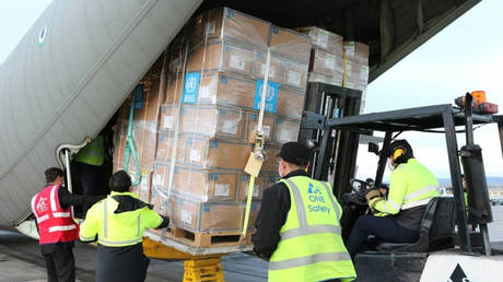 Workers unload medical equipment and coronavirus testing kits provided by the World Health Organisation in Iran's capital Tehran © World Health Organization / AFP