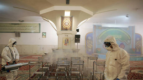 A medical team sanitizes a shrine in Mashhad, Iran February 27, 2020.