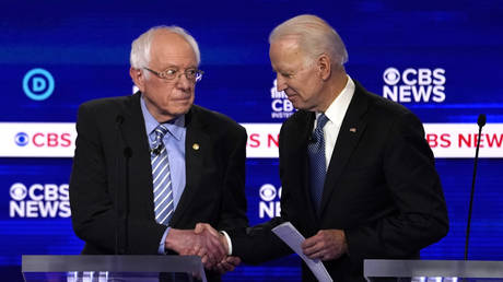 Senator Bernie Sanders shakes hands with former Vice President Joe Biden