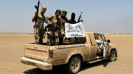 FILE PHOTO: Militants the Syrian Islamist rebel group Jabhat Fateh al-Sham are seen on a pickup truck in the Idlib province, Syria, on August 1, 2016.