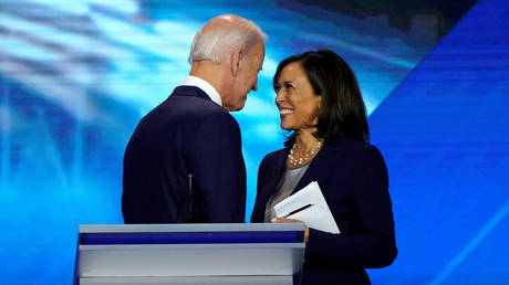 Joe Biden talks with Kamala Harris at Democratic presidential debate in Houston, Texas.