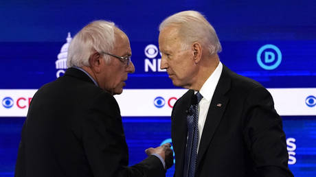 Democratic 2020 U.S. presidential candidates Senator Bernie Sanders and former Vice President Joe Biden talk at the tenth Democratic 2020 presidential debate at the Gaillard Center in Charleston, South Carolina, U.S. February 25, 2020. © REUTERS/Jonathan Ernst