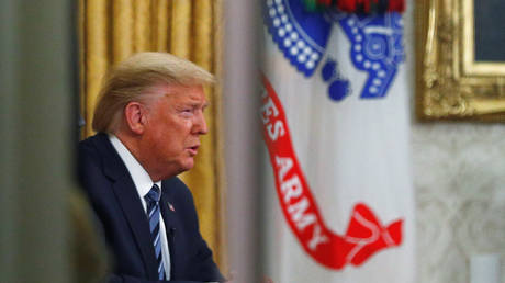 US President Donald Trump addresses the nation during a live television broadcast regarding the COVID-19 coronavirus pandemic, from inside the Oval Office at the White House in Washington, DC, March 11, 2020.
