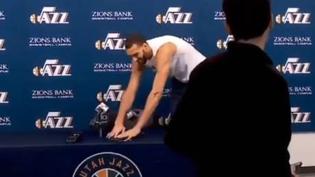 Utah Jazz player Rudy Gobert touches reporters' microphones and recorders at a press conference, apparently mocking fears over the coronavirus, March 9, 2020.