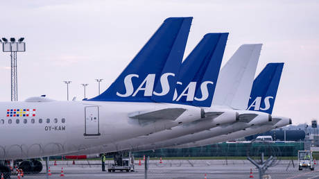 Scandinavian Airlines (SAS) Airbus A320 planes are parked at Copenhagen airport in Kastrup, Denmark on March 15, 2020.