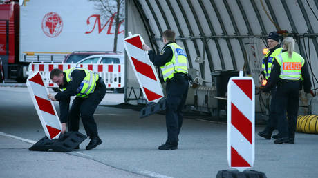 German police officers set up road blocks at the Austrian-German border crossing point near the village of Kiefersfelden, Germany, on March 16, 2020.