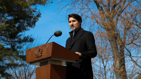 FILE PHOTO. Canada's Prime Minister Justin Trudeau speaks to the media outside his home in Ottawa, March 2020