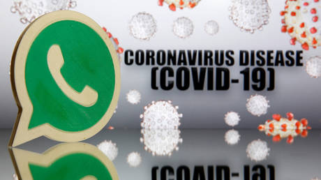 A 3D-printed Whatsapp logo is seen in front of displayed coronavirus disease (COVID-19) sign. © REUTERS / Dado Ruvic/ Illustration