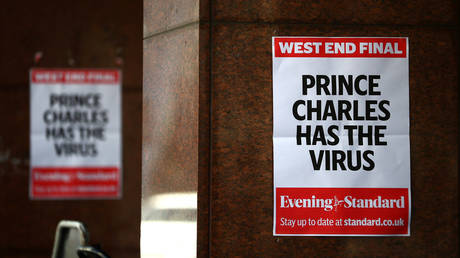 Posters reading "Prince Charles has the virus" are seen in London, Britain, March 26, 2020.