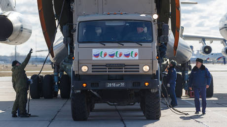 FILE PHOTO: Russian servicemen load medical equipment and special disinfection vehicles into a cargo plane headed for Italy, at a military airdrome near Moscow.