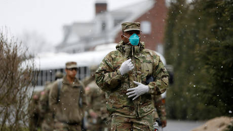 FILE PHOTO: Soldiers and airmen from the New York Army and Air National Guard arrive to sanitize and disinfect a building during the coronavirus outbreak in New Rochelle, New York.