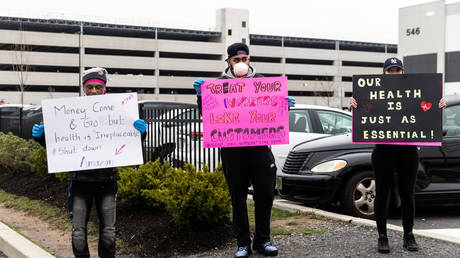FILE PHOTO: Protesters hold signs at Amazon building during the outbreak of the coronavirus disease (COVID-19), in New York City, US, on March 30, 2020.