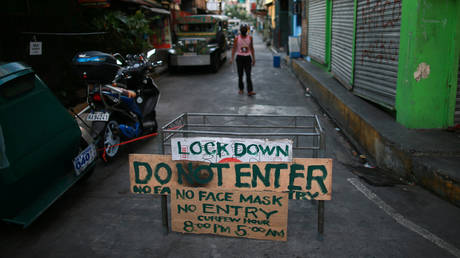 FILE PHOTO: A makeshift barricade blocks a street from outsiders to protect a neighborhood from Covid-19, in Manila, Philippines.