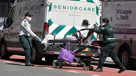 A person is wheeled to an ambulance outside a hospital in New York City