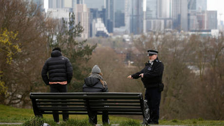 A police officer confronts people at Greenwich Park in London, Britain, March 31, 2020.