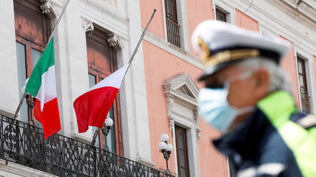 Flags of Italy, the European Union and Bari flutter to half mast to honor the country's dead due to coronavirus disease, in Bari, Italy
