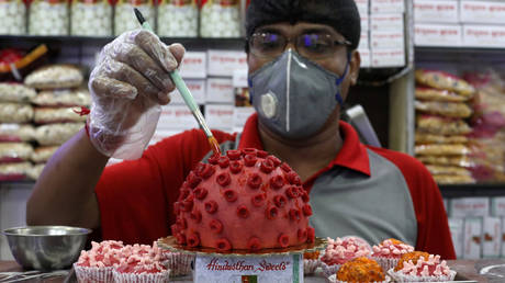 FILE PHOTO: A confectioner applies finishing touches to a replica of coronavirus made out of sweets at a confectionary workshop in Kolkata, India.