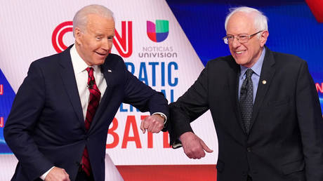 Joe Biden (left) and Bernie Sanders (right) greet each other at the Democratic presidential debate, Washington, DC, March 15, 2020.