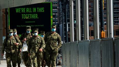 FILE PHOTO: US military personnel wearing face masks arrive at the Jacob K. Javits Convention Center in New York City as the Covid-19 outbreak continues.