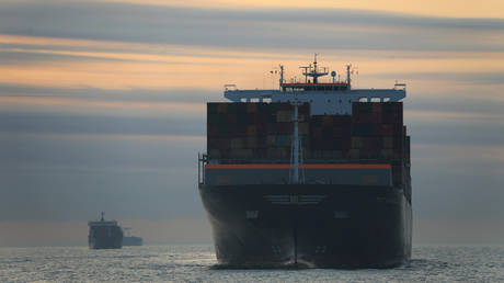A cargo ship carrying containers approaches a port in Ningbo, Zhejiang province, China © Reuters