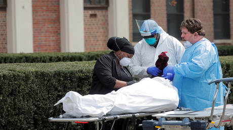 FILE PHOTO: Healthcare workers prepare to transfer the body of a deceased person at a Brooklyn hospital during the Covid-19 outbreak in New York.