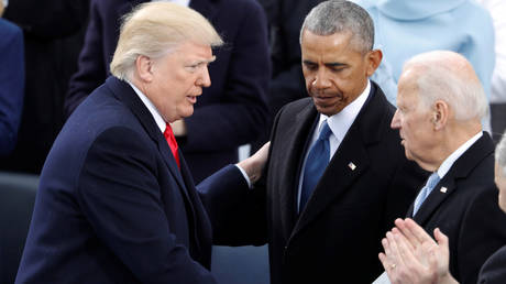 FILE PHOTO: US President Donald Trump greets former Vice President Joe Biden and former President Barack Obama after being sworn in as the 45th president of the US in Washington, DC.