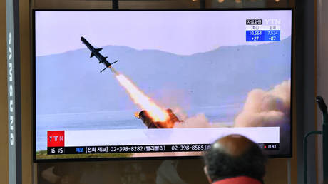 FILE PHOTO: A man watches a television news broadcast showing file footage of a North Korean missile test, at a railway station in Seoul, April 14, 2020