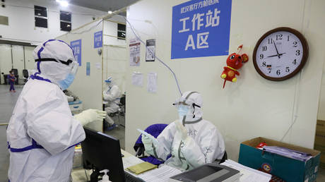 FILE PHOTO: Medical workers in protective suits inside a makeshift hospital in Wuhan, Hubei province, China, February 15, 2020