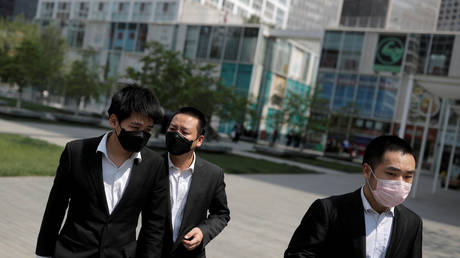 Office workers wear protective gear near Beijing's Central Business District as the spread of the new coronavirus disease continues in China