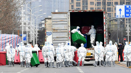 FILE PHOTO: Workers in protective suits disinfect the Huanan seafood market, where the coronavirus is widely believed to have first surfaced, in Wuhan, China.