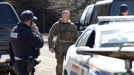 RCMP officers maintain a road block after neutralizing Nova Scotia shooter