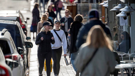 FILE PHOTO: People pass by an outdoor restaurant, amid the coronavirus disease (COVID-19) outbreak, in Stockholm, Sweden, on April 20, 2020.