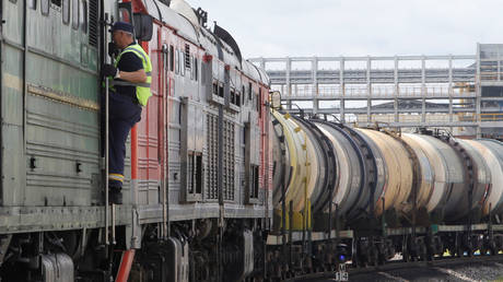 An employee stands in an oil tank train at the Taneco refinery complex, which is part of Russia's oil producer Tatneft group of companies