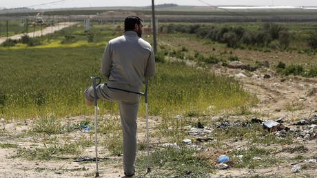 With mass rallies cancelled, a disabled Palestinian attends an event marking Land Day near the Israel-Gaza border, on March 30, 2020