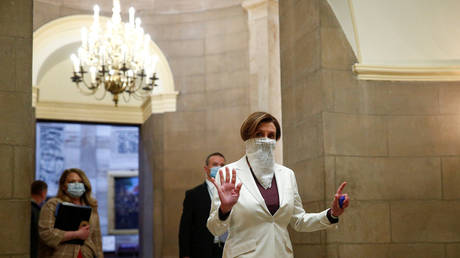 Nancy Pelosi wears a face mask as she walks to the House Chamber during the spread of the coronavirus disease on Capitol Hill in Washington