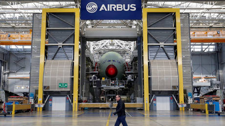 An employee walks in front of the final assembly line at Airbus headquarters in Blagnac near Toulouse, France.